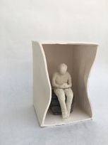 Stoneware Figure sitting in a porcelaine FC box 